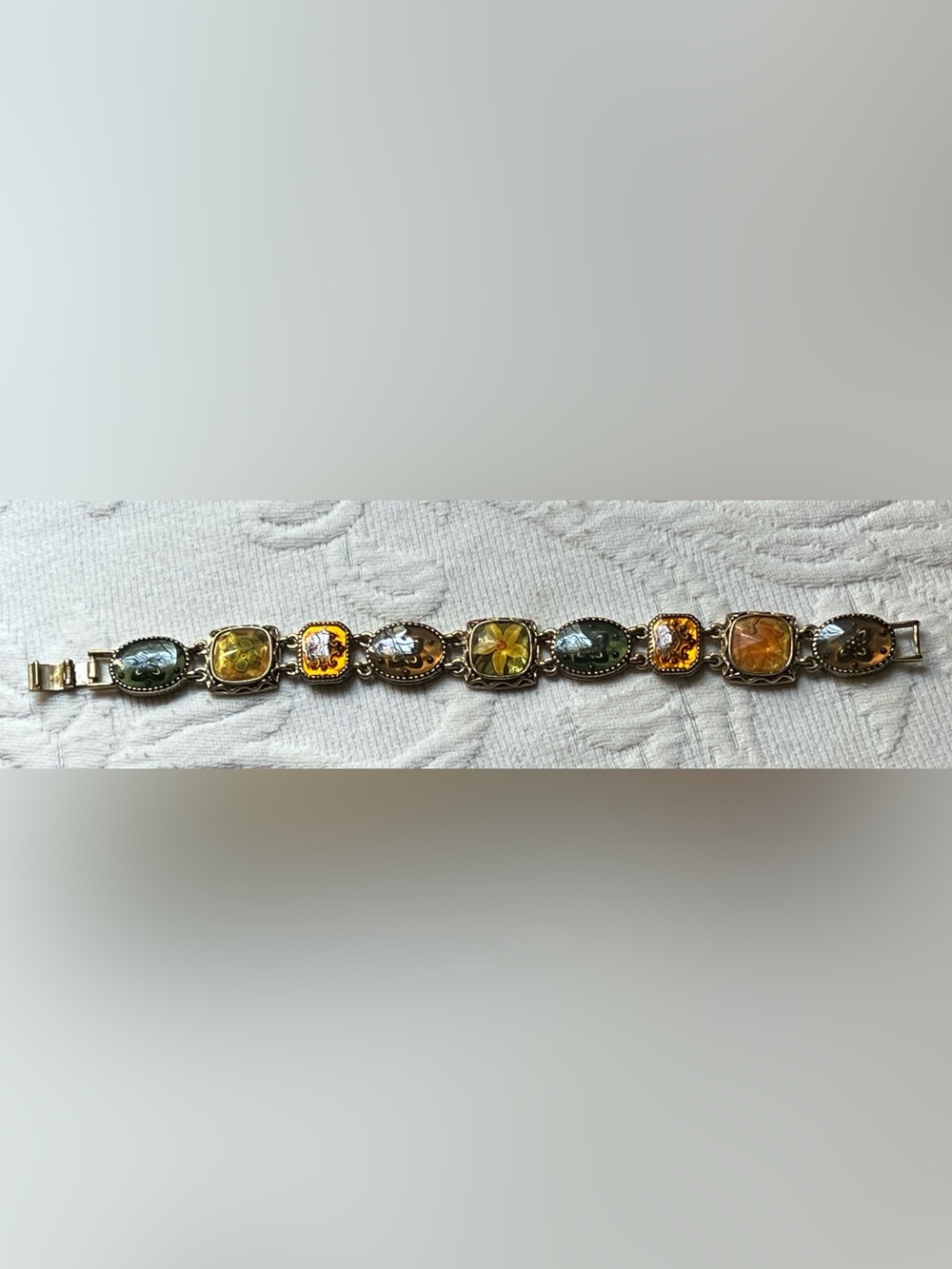 Vintage Liz Clayborne glass and acrylic floral motif, gold tone link bracelet.